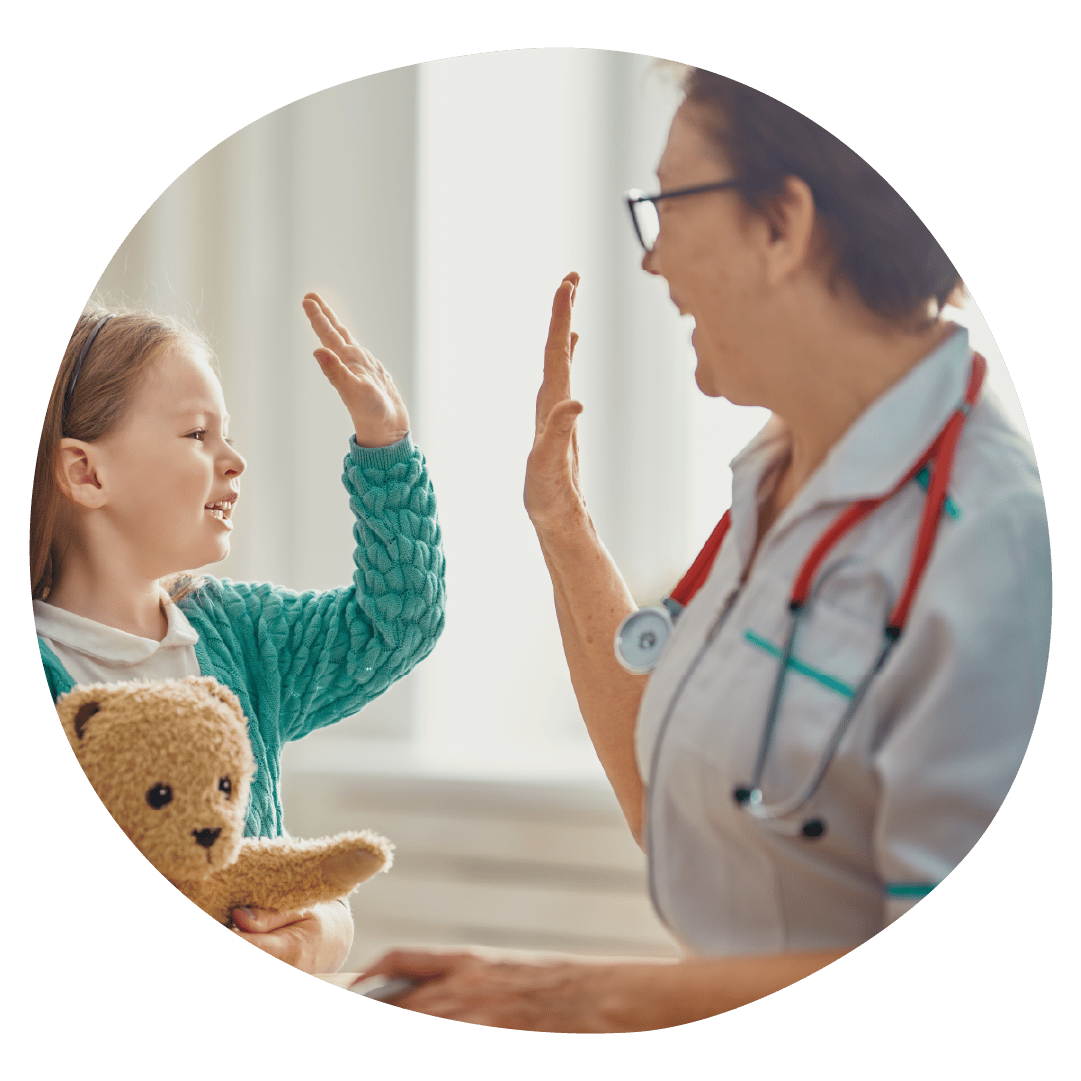 A clinician and young patient giving each other a high five