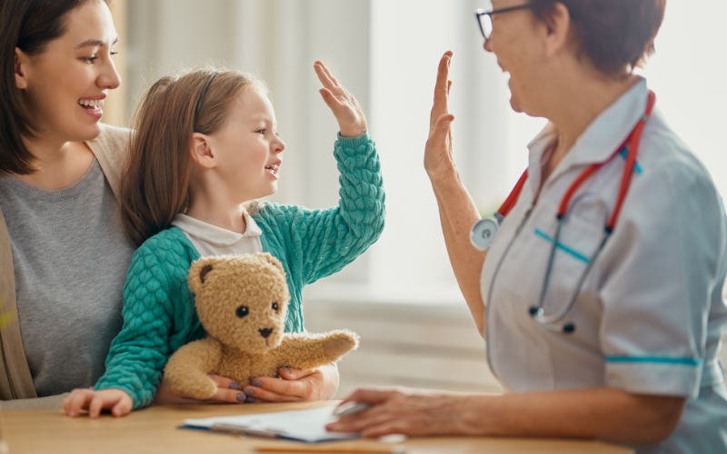 Little girl giving a health care professional a high five