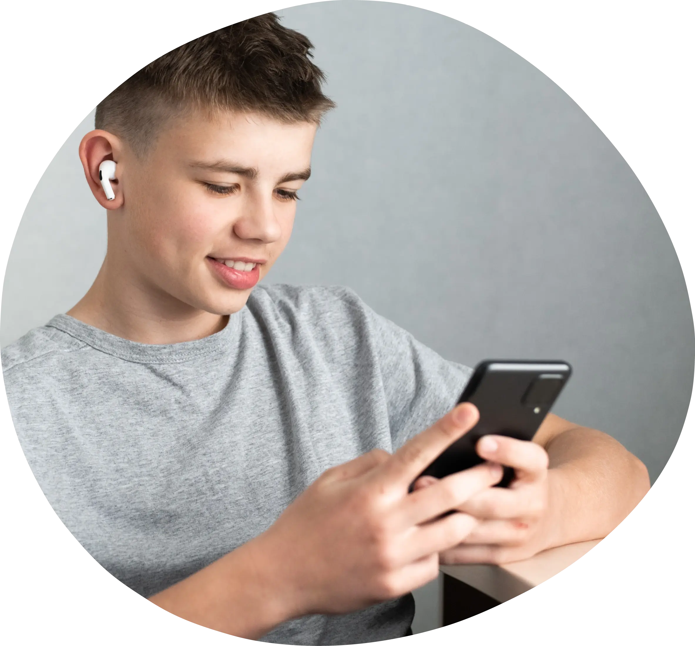 Teenage boy using a smart phone and wearing headphones