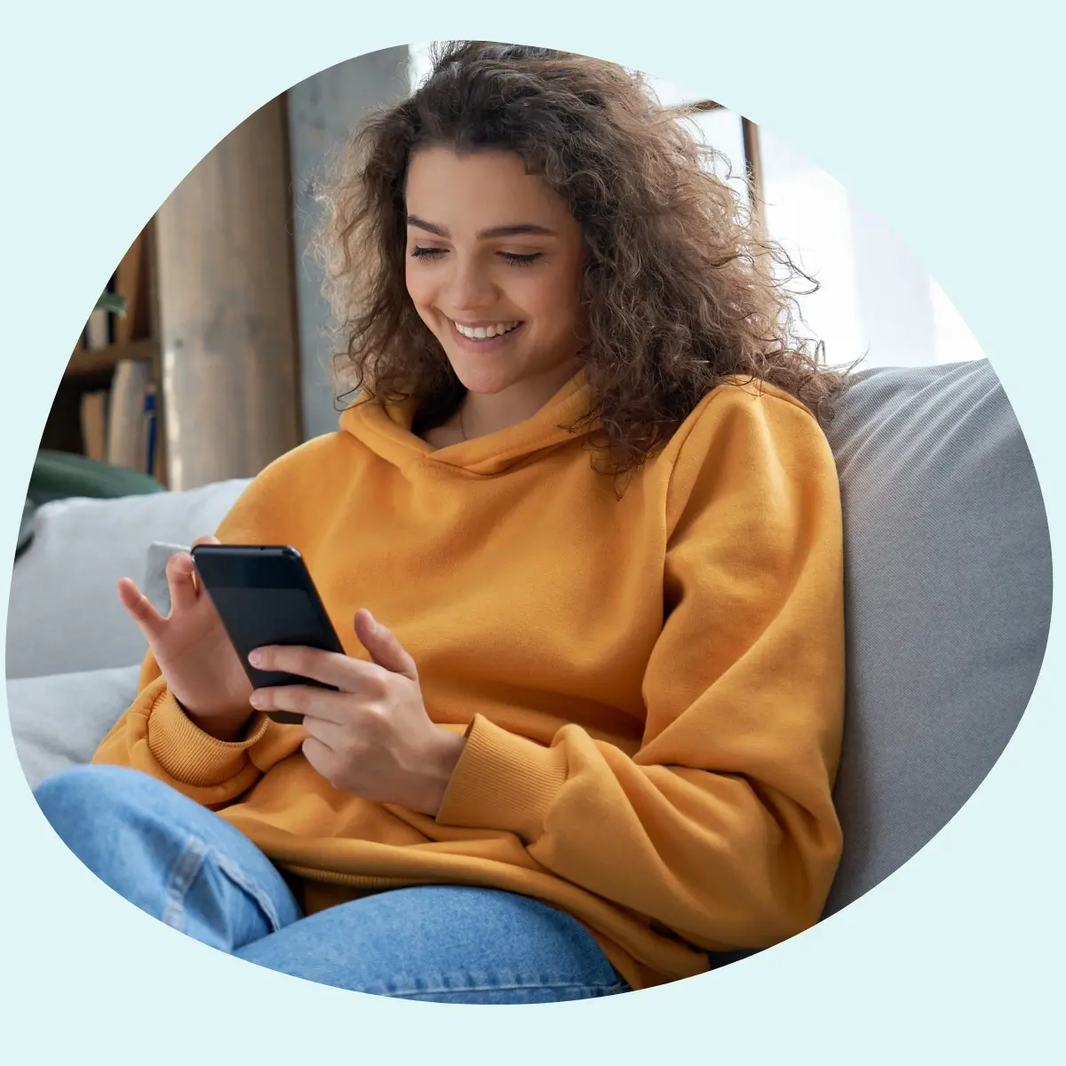Teenage girl on phone light blue background Teenage girl on phone light blue background